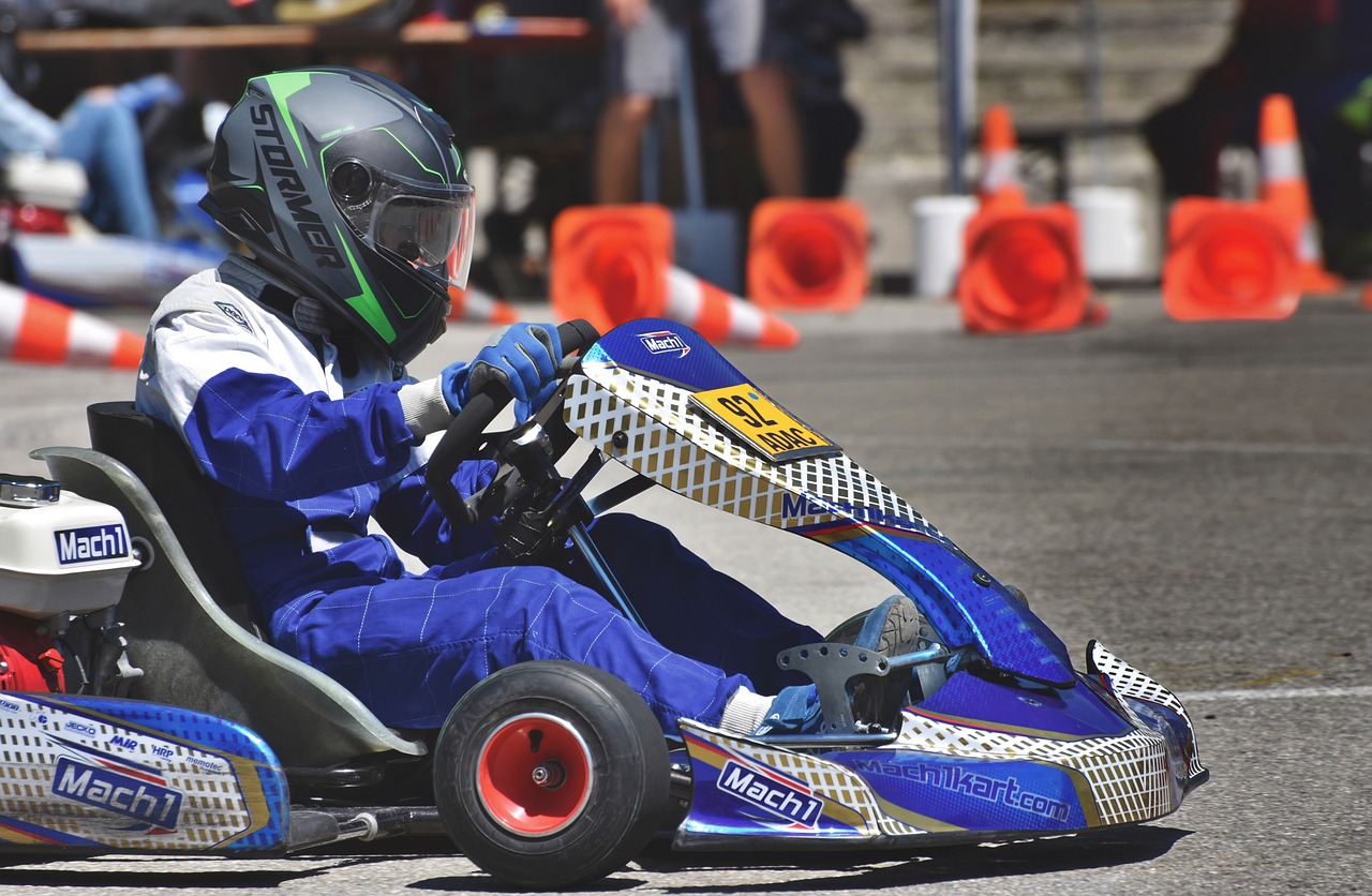 A young man in a blue go-kart
